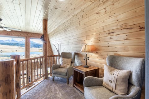 Escape into relaxation in the quaint loft reading nook at Mountain Lake Lodge. Cozy up with a book and immerse yourself in tranquility amidst breathtaking views.