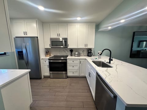Your gourmet kitchen awaits with stainless steel appliances, marble countertops, and everything needed to create memorable meals during your stay.