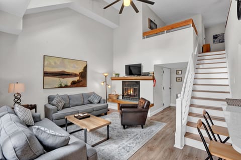 Living room with vaulted ceiling and fireplace