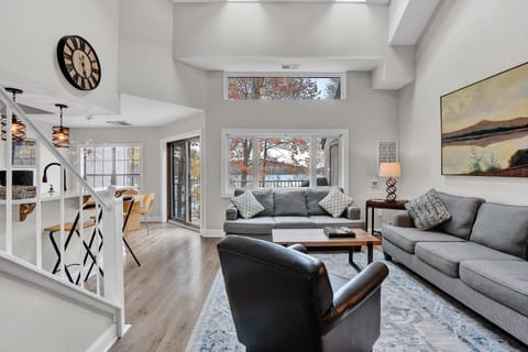 Bright and spacious living room with views, skylights and fireplace