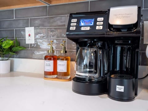 Wake up to the aroma of freshly brewed coffee from our sleek coffee maker.