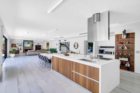 The ample open-concept chef's kitchen with waterfront view feature high end appliances and.