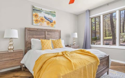  Bright and cheerful bedroom with large windows and cozy bedding.