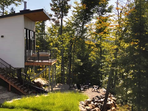 Exterior view of the chalet with a wood-burning outdoor fireplace.