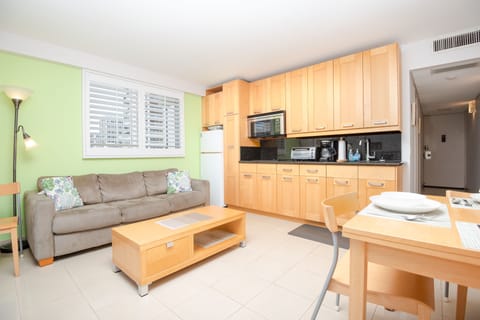 Living area with kitchenette, dining table, and cable tv