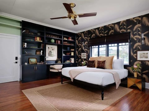 Timeless elegance meets island charm in this Lokelani Suite at The Historic Wailuku Inn. Cozy up with a book, sink into plush comfort, and experience pure relaxation.
