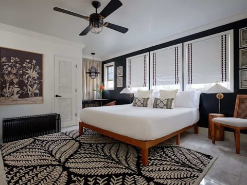 Experience luxe comfort in the Puakenikeni Suite! Chic design & a dreamy bed promise a restful escape. Book your stylish getaway!