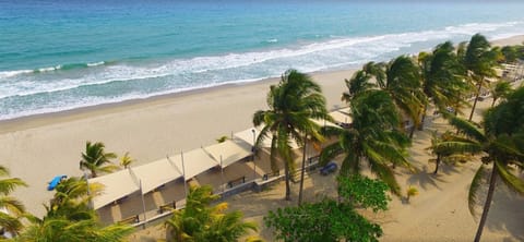 On the beach, white sand, sun loungers, beach towels