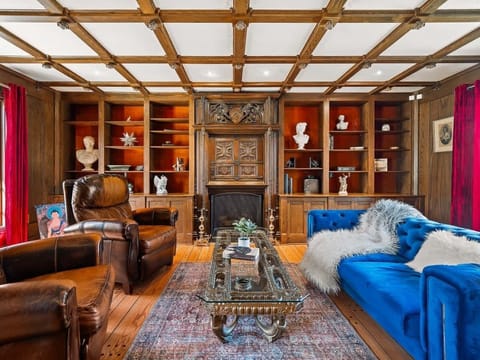 Inviting lounge w/ built-in shelving, plush seating & rich wood tones.
