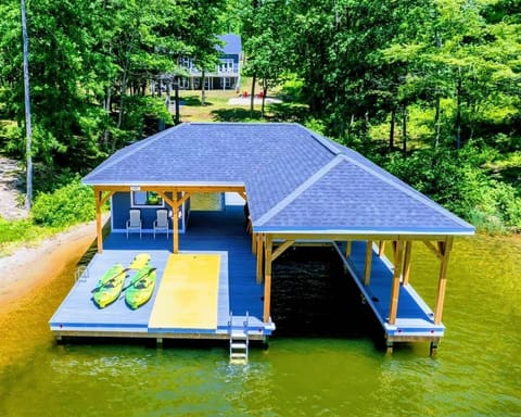 Charming lakeside boathouse with seating area and easy water access, perfect for relaxation and recreation
