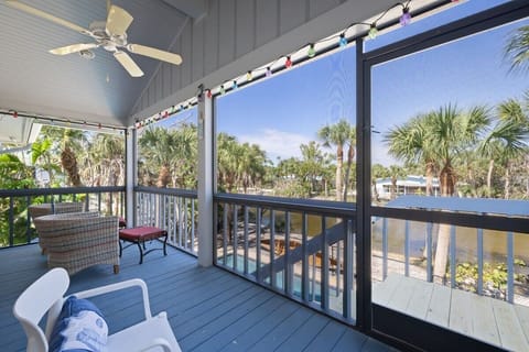 Back patio with ample seating, leading down to pool via stairs