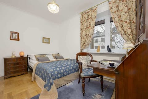Elegant and cozy bedroom with a double bed and cabinet with desk.