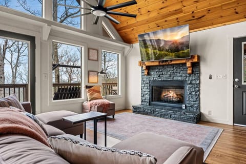 Spacious living room includes a gas fireplace (seasonal) along with a large Smart TV and plenty of seating.