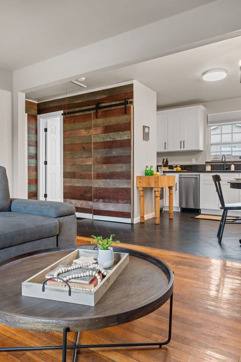 Full size stacked washer and dryer behind barn door