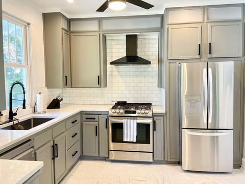 Well equipped kitchen with brand new fridge, gas stove and oven, and dishwasher