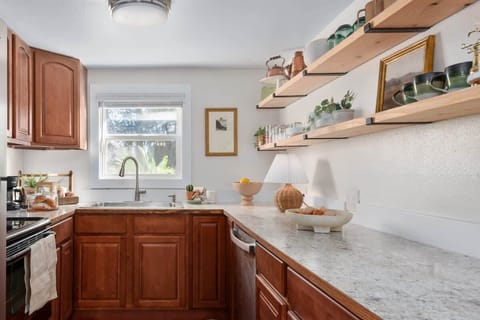The fully outfitted kitchen features a brand new stainless steel fridge, a high efficiency dishwasher, electric stove and range. The beautiful open shelves make finding what you need easy!