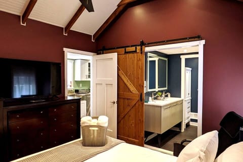 Master Bedroom & en suite bathroom with sliding barn privacy door, dual vanity, jet tub and private toilet with sliding glass privacy door