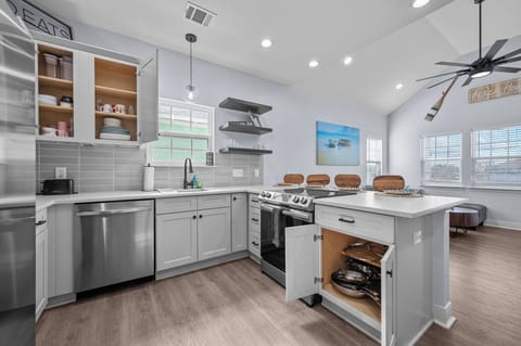 Cabinets are fully stocked with dishes, cookware, glasses and cups.