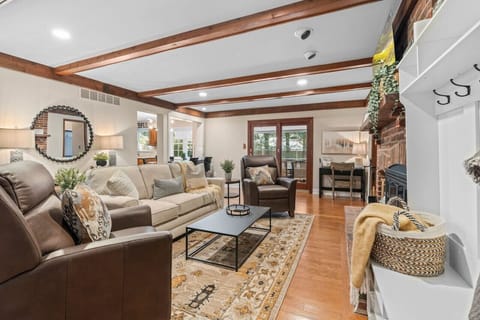 Charming Living Area with Hardwood Floors & Beams