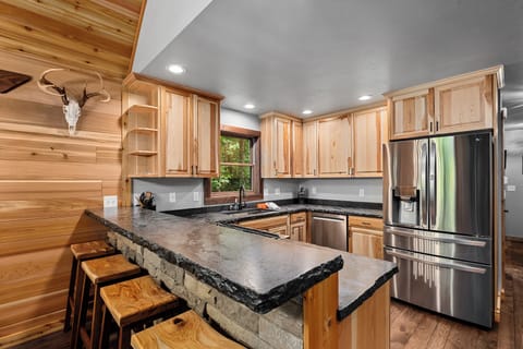 Additional Kitchen bar top dining. Oversized refrigerator to hold all your supplies. Extra refrigerator in the garage (not pictured).