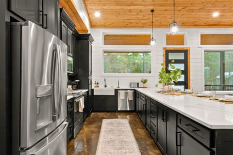 A large stainless-steel refrigerator and an extended counter that provides plenty of room for meal prep.