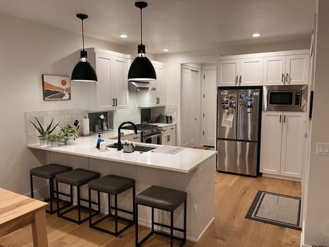 The bottom floor is an open plan that includes the living room, kitchen & dining