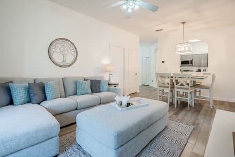 Modern living room with a spacious sectional sofa and open dining area.
