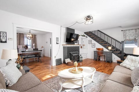 Living room with 55" Roku TV and cozy seating, desk.