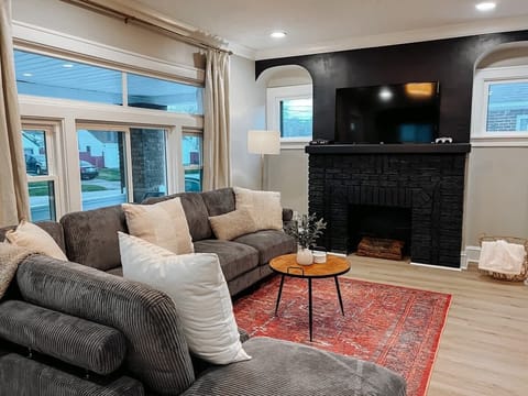 Comfortable living room w/ fireplace, plush seating & large TV for cozy movie nights