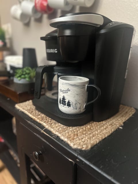 Coffee station with a Keurig machine offering both single-serve K-Cup and full-pot brewing options.