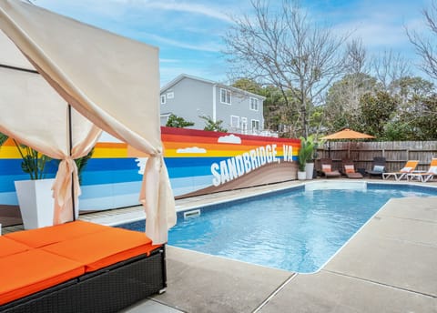 Private pool with mural wall, daybed, multiple loungers