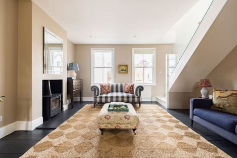 A bright, light-filled living room with high ceilings and elegant furnishings
