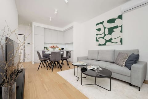 Bright modern living room with grey sofa and minimalist decor