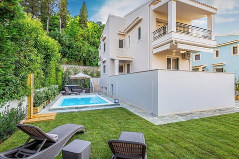 "Welcome to House Magdalena! A tranquil retreat nestled amidst lush greenery and a sparkling pool."