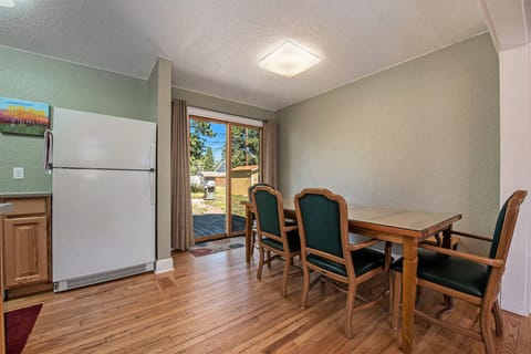 Your Vacation House Estes Park, Kitchen/Dining area, with refrigerator, and dining table with seating for 4 by sliding patio door.