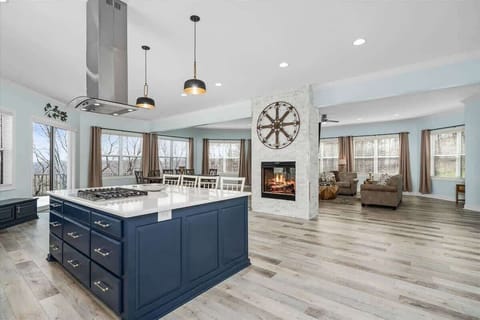 The enormous marble island boasts a gas stove and is stocked with all the essential kitchen amenities.