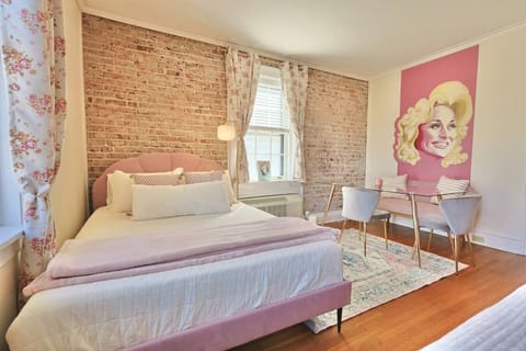 Charming Bedroom Retreat: Stunning brick walls and playful decor create a vibrant haven!