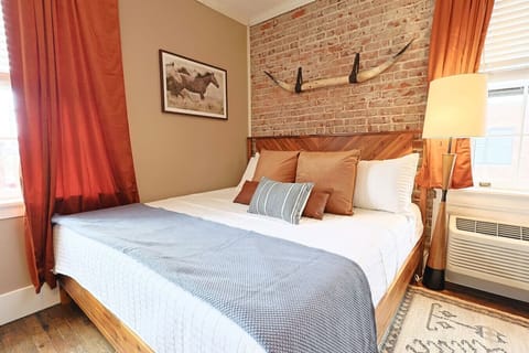 Bedroom Retreat: Drift into sweet dreams surrounded by industrial charm and warm, inviting decor!