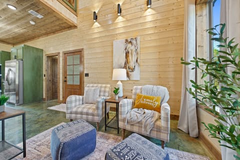 Discover the perfect living-room cozy conversation  spot – two cozy armchairs with ottomans.