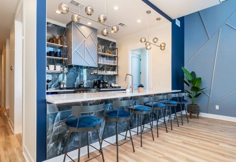 The Island Counter Has 6 Stools, Matching the Sapphire Blue Theme of the Home