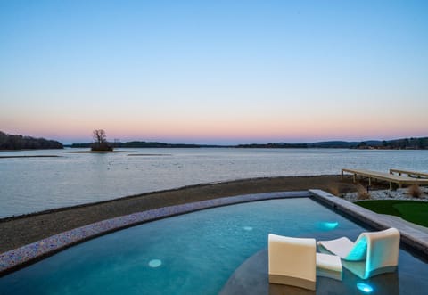 As the sun begins to set, the infinity-edge pool creates the perfect spot to unwind while soaking in uninterrupted lake views.