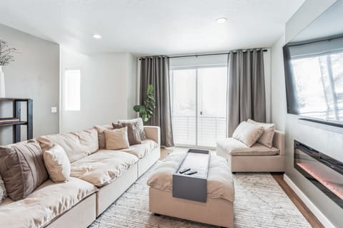 Living room with cozy fireplace and LARGE TV.
