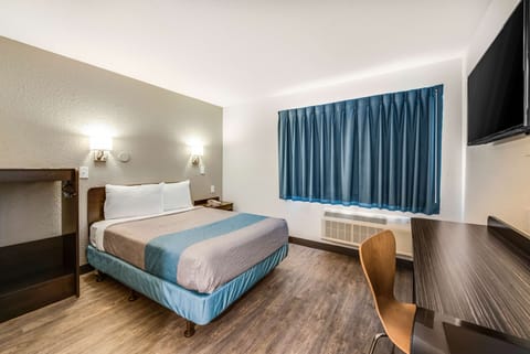 Desk, laptop workspace, blackout drapes, iron/ironing board