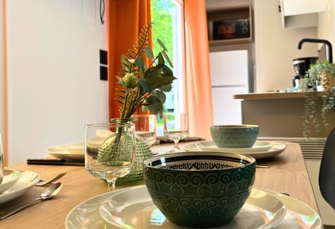 Set for a delightful meal, this dining area radiates warmth and charm, inviting guests to enjoy every bite in a cozy setting.