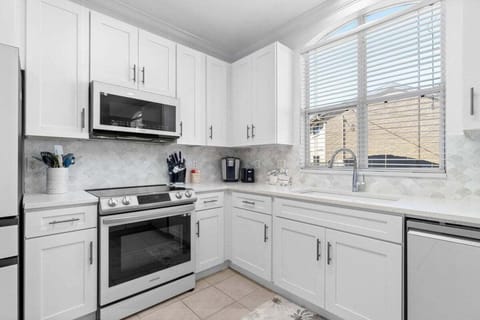 Kitchen with oven, microwave, refrigerator, and more.