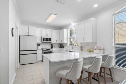 Three barstools at kitchen bar overlooking the kitchen.
