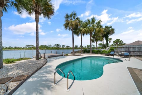 Private pool paradise with stunning lake views and swaying palm trees creating your perfect tropical retreat.