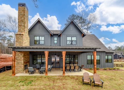 Back shows covered porch, seating, dining & wood-burning fireplace-tv(to come).
