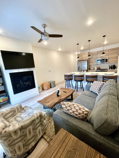 Sink into Comfort with Sofa, Swivel Chair, Coffee Table, Fireplace, TV & Fan