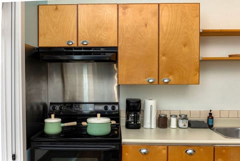 A fully equipped kitchen with blender and a drip coffee machine